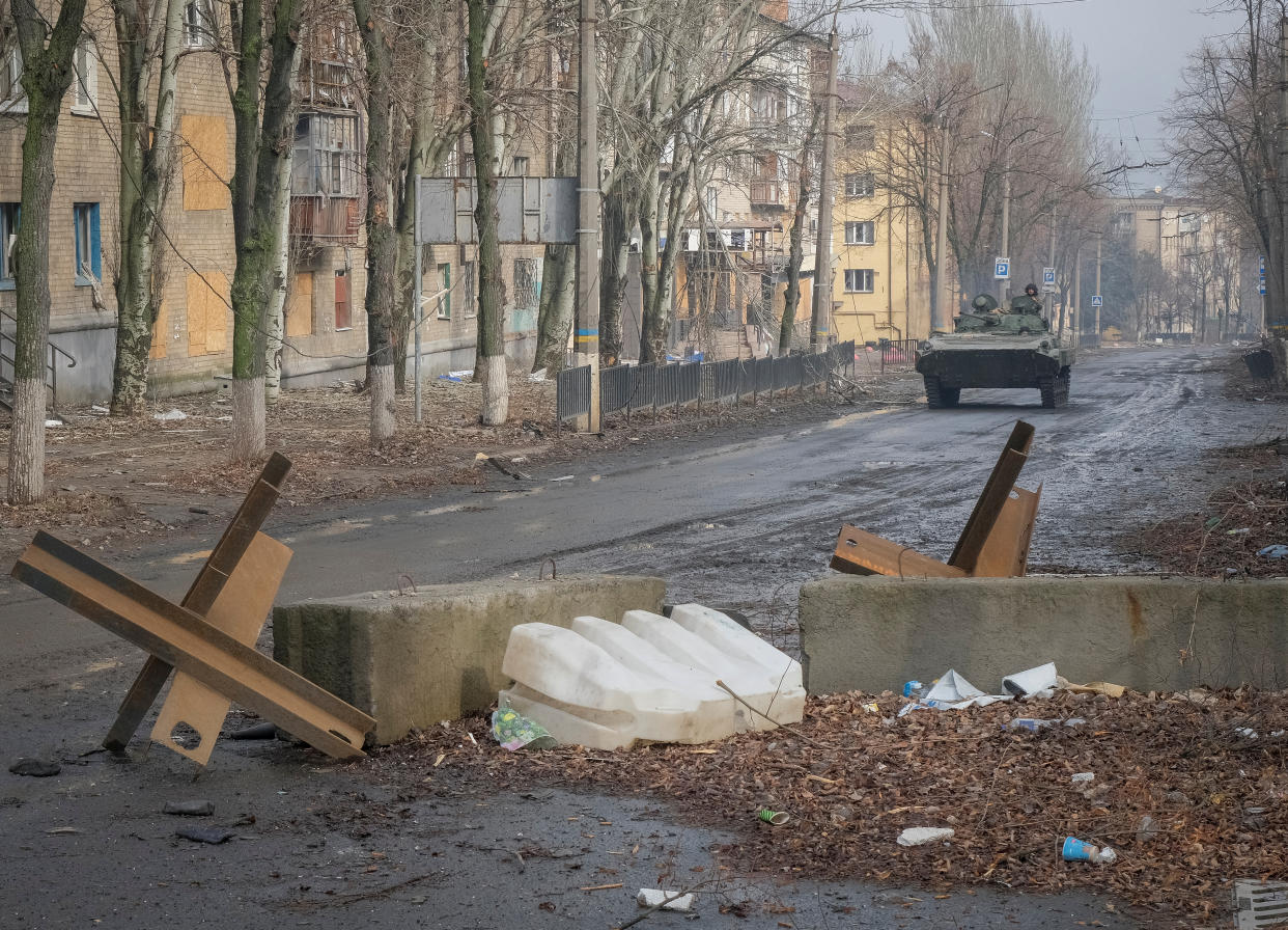 Ukrainian service members ride a BMP-2 infantry fighting vehicle along an empty street, as Russia's attack on Ukraine continues, in the frontline city of Bakhmut, Ukraine February 27, 2023. REUTERS/Alex Babenko