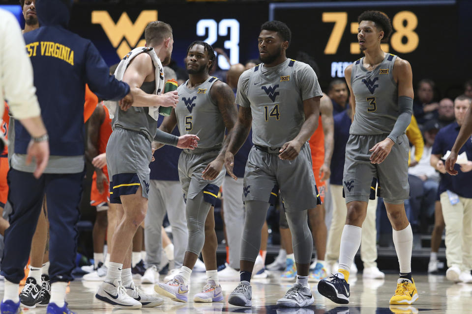 West Virginia players meet on court during the first half of an NCAA college basketball game against Auburn on Saturday, Jan. 28, 2023, in Morgantown, W.Va. (AP Photo/Kathleen Batten)