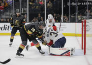 Florida Panthers goaltender Sam Montembeault (33) covers up the puck as Vegas Golden Knights right wing Reilly Smith (19) reaches for it during the second period of an NHL hockey game Saturday, Feb. 22, 2020, in Las Vegas. (AP Photo/Marc Sanchez)