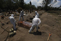 Cemetery workers in a protective gear lower a coffin wrapped in plastic, containing a COVID-19 victim, into a gravesite at the San Lorenzo Tezonco Iztapalapa cemetery in Mexico City, Tuesday, June 2, 2020. The coronavirus toll in Mexico soared to a new daily high Wednesday, more than double the previous one-day record. (AP Photo/Marco Ugarte)