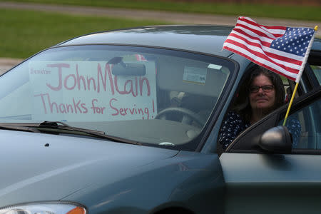 Debbie Rasmussen waits for a glimpse of the the funeral procession and caisson containing the body of the late Senator John McCain as it heads to the cemetery for a private burial at the U.S. Naval Academy in Annapolis, U.S., September 2, 2018. REUTERS/Mary F. Calvert