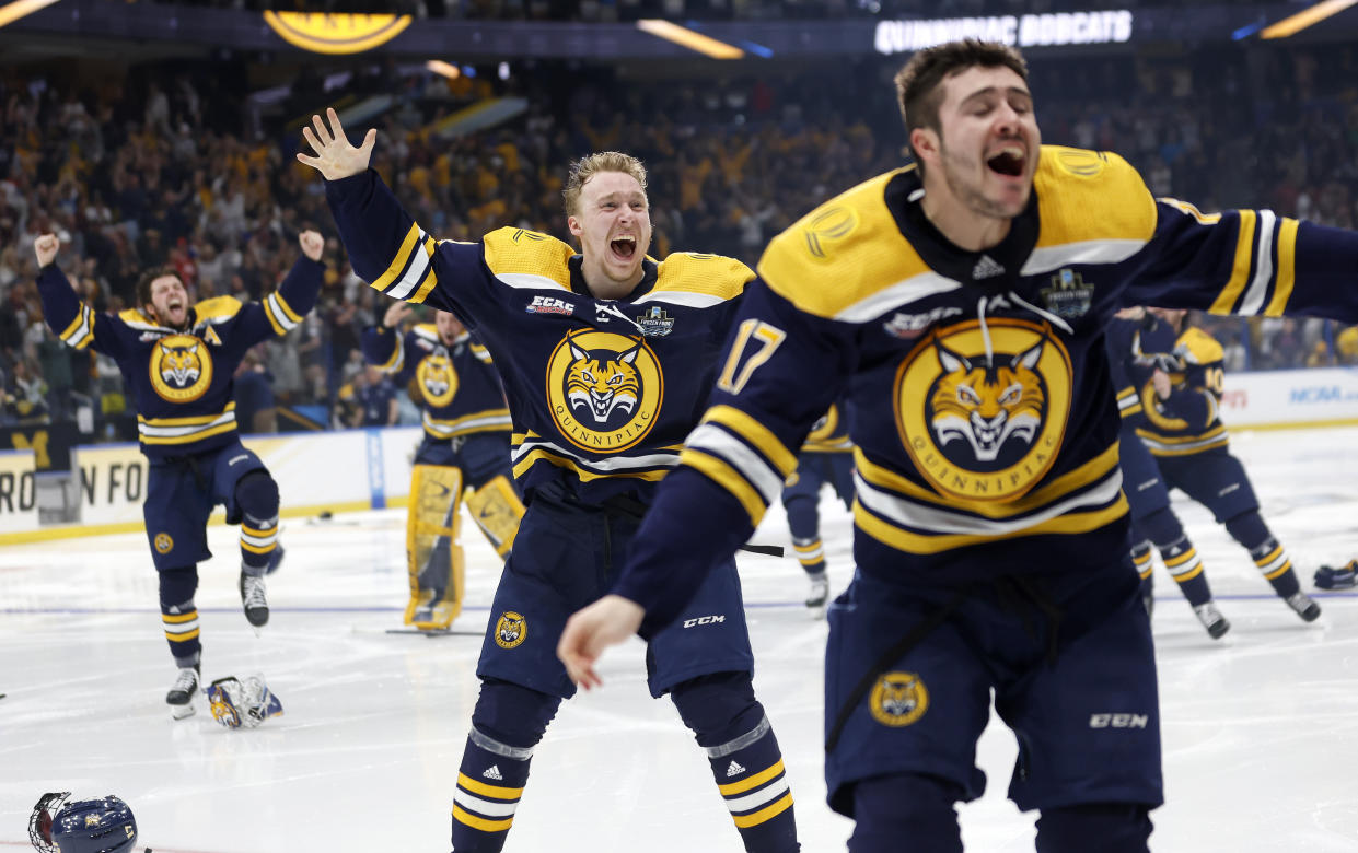 TAMPA, FLORIDA - APRIL 08: CJ McGee #5 and Joey Cipollone #17 of the Quinnipiac Bobcats celebrate after winning the championship game of the 2023 Frozen Four against the Minnesota Golden Gophers at Amalie Arena on April 08, 2023 in Tampa, Florida. (Photo by Mike Ehrmann/Getty Images)
