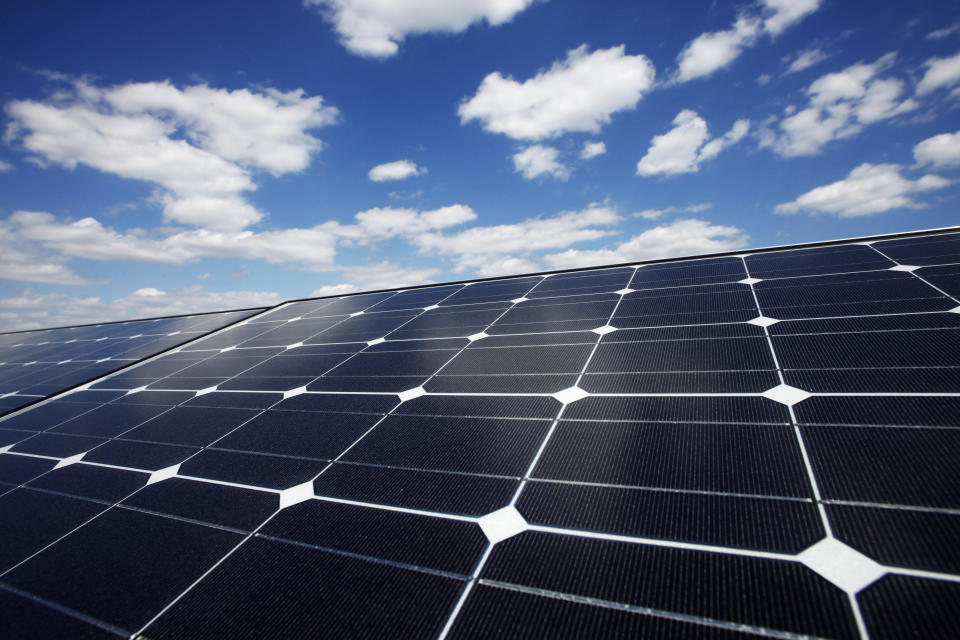 FILE - In this Friday, April 29, 2011, file photo, solar panels line the roof of Ikea's Brooklyn store, in New York. The solar panel installer SolarCity said in December 2013 that it is starting to offer battery packs made by electric car maker Tesla Motors, whose CEO is also the chairman of SolarCity. The battery packs will allow customers a way to provide backup power and lower electric bills.  (AP Photo/Mark Lennihan, File)