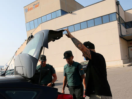 FILE PHOTO - Civil Guards officers stop a car for inspection as it leaves Indugraf Offset SA printing house in Constanti town, near Tarragona, Spain, September 8, 2017. REUTERS/Albert Gea/File Photo