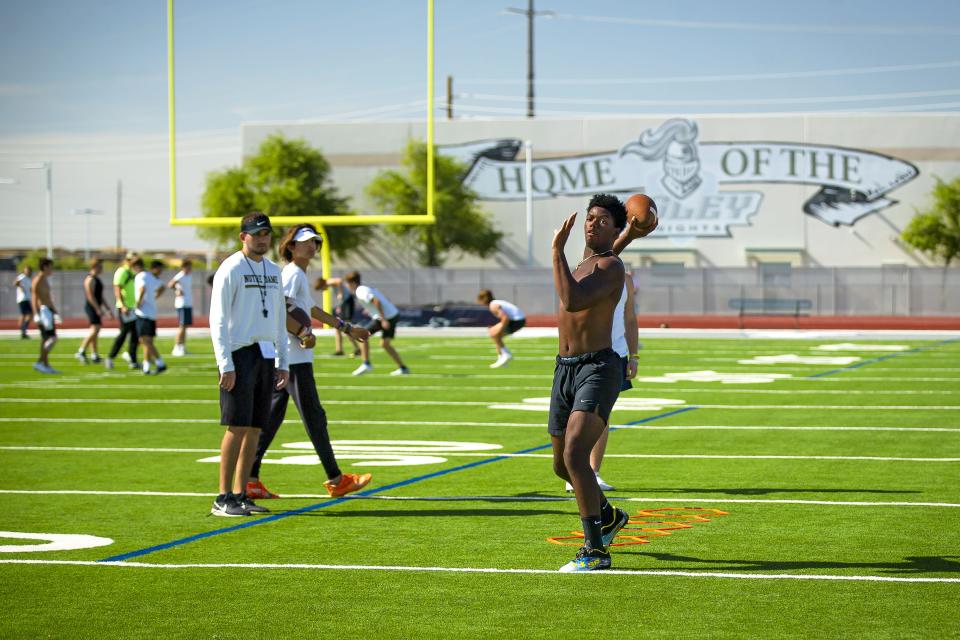 Freshman quarterback Jamar Malone prepares to throw the ball after a ladder drill during spring football practice at Higley High School in Gilbert on May 5, 2022.