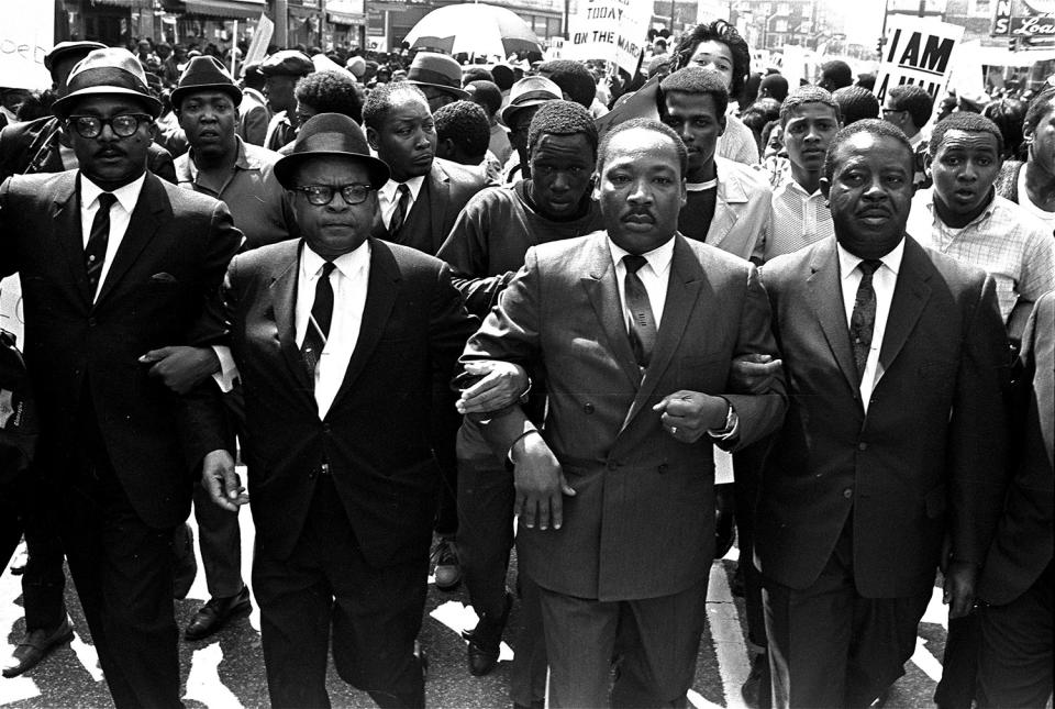 <p>The Rev. Ralph Abernathy, right, and Bishop Julian Smith, left, flank Dr. Martin Luther King, Jr., during a civil rights march in Memphis, Tenn., March 28, 1968. (AP Photo/Jack Thornell) </p>