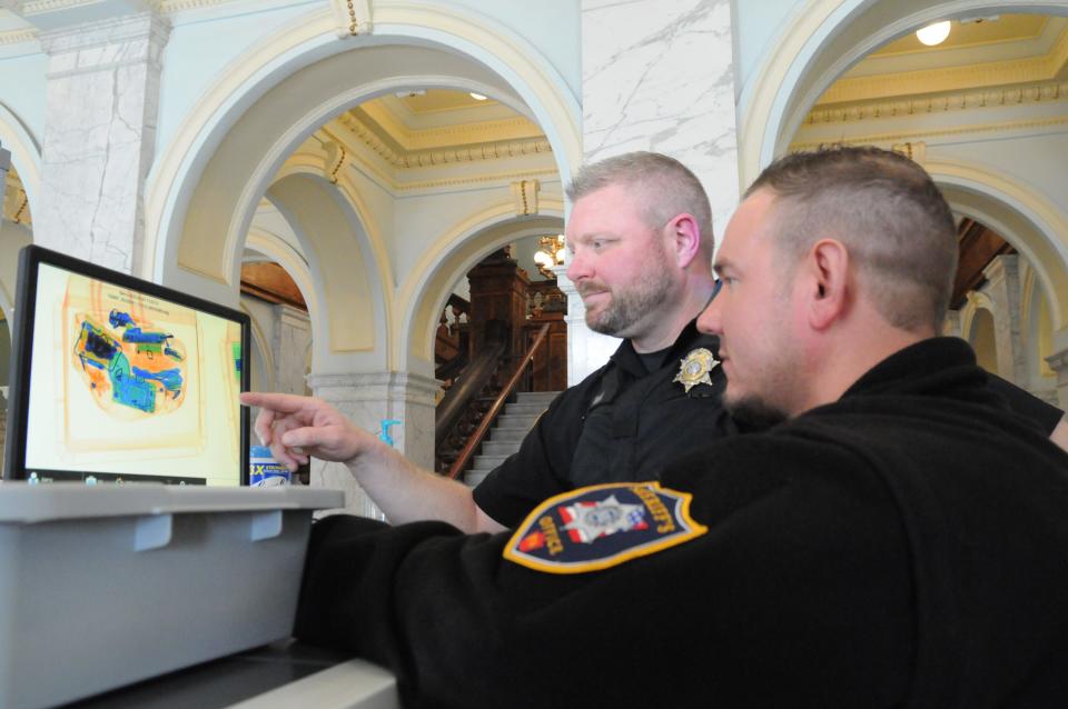 Somerset County Sheriff Deputy Dusty Ritchea, front, recently promoted to full-time in his position, and Somerset County Sheriff Dustin Weir, work together at the courthouse's metal detector.