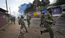 <p>Kenyan police fire tear gas at protesters throwing rocks in the Kibera slum of Nairobi, Kenya, on May 23, 2016. The protesters are calling for the electoral commission to be dissolved. (Ben Curtis/AP) </p>