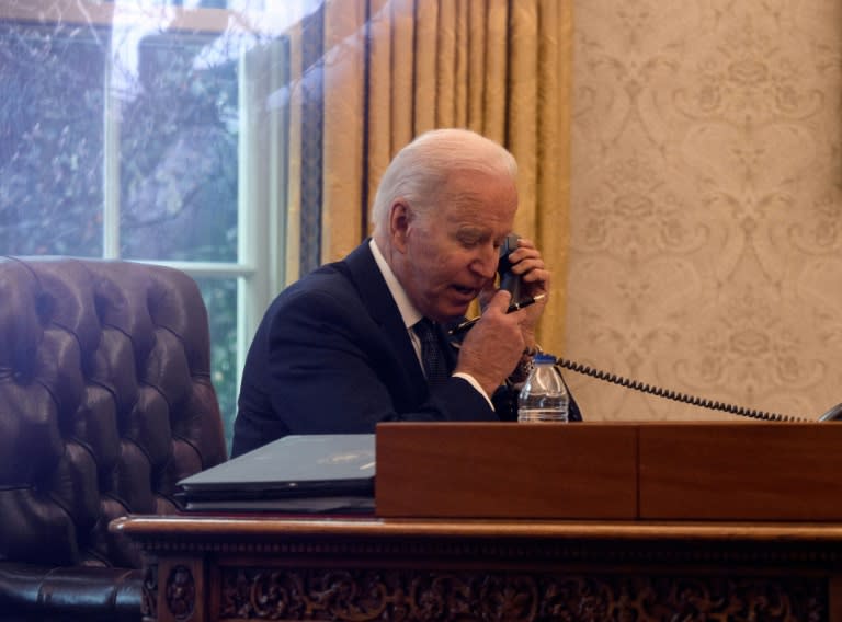 US President Joe Biden speaks on the phone with his Ukrainian counterpart Volodymyr Zelensky, in the Oval Office on December 9, 2021 (AFP/Nicholas Kamm)