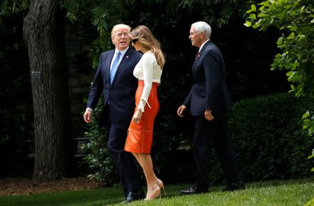 U.S. President Donald Trump looks back toward his wife Melania and Vice President Mike Pence as he departs the White House to embark on a trip to the Middle East and Europe in Washington, U.S., May 19, 2017. REUTERS/Kevin Lamarque