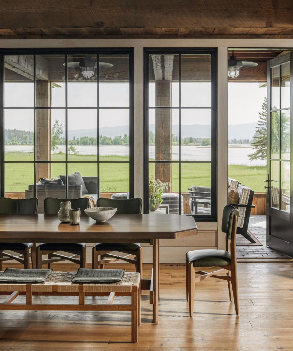 Bench, dining table, green chairs, glass windows