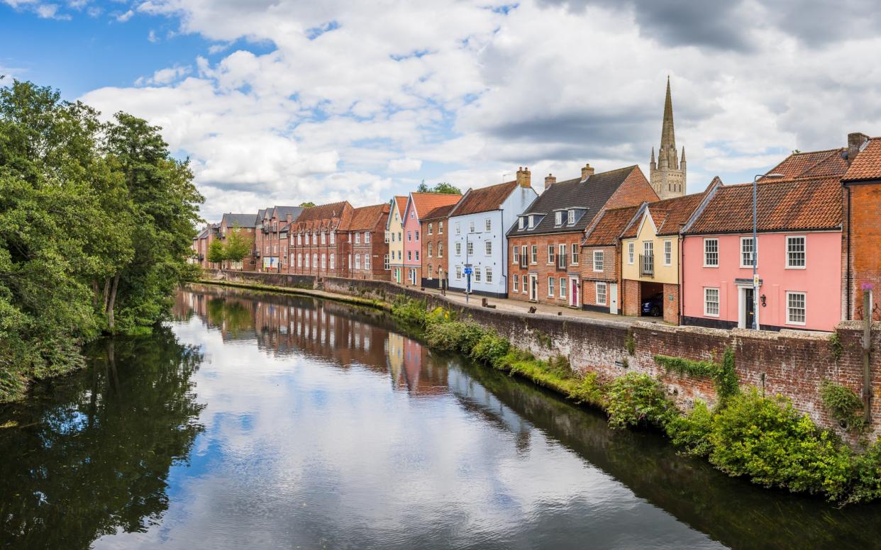 Pretty multi coloured houses pictured from Fye Bridge lining the River Wensum in Norwich