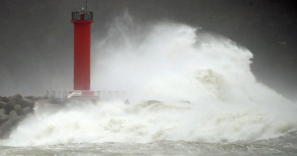 A high wave hits a lighthouse at a port in Gyeongju, South Korea, Monday, Sept. 7, 2020. A powerful typhoon damaged buildings, flooded roads and knocked out power to thousands of homes in South Korea on Monday after battering islands in southern Japan. (Kim Hyun-tai/Yonhap via AP)