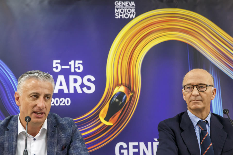 Olivier Rihs, left, General Manager of Geneva's International Motor Show, and Maurice Turrettini, right, President of Geneva's International Motor Show, announce that the motor show is cancelled, during a press conference at the Palexpo in Geneva, Switzerland, Friday, Feb. 28, 2020 The 90th edition of the International Motor Show, scheduled to begin on March 5th, is cancelled due to the advancement of the (Covid-19) coronavirus in Switzerland. The Swiss confederation announced today that all events involving more than 1,000 people would be banned until 15 March. (Salvatore di Nolfi/Keystone via AP)