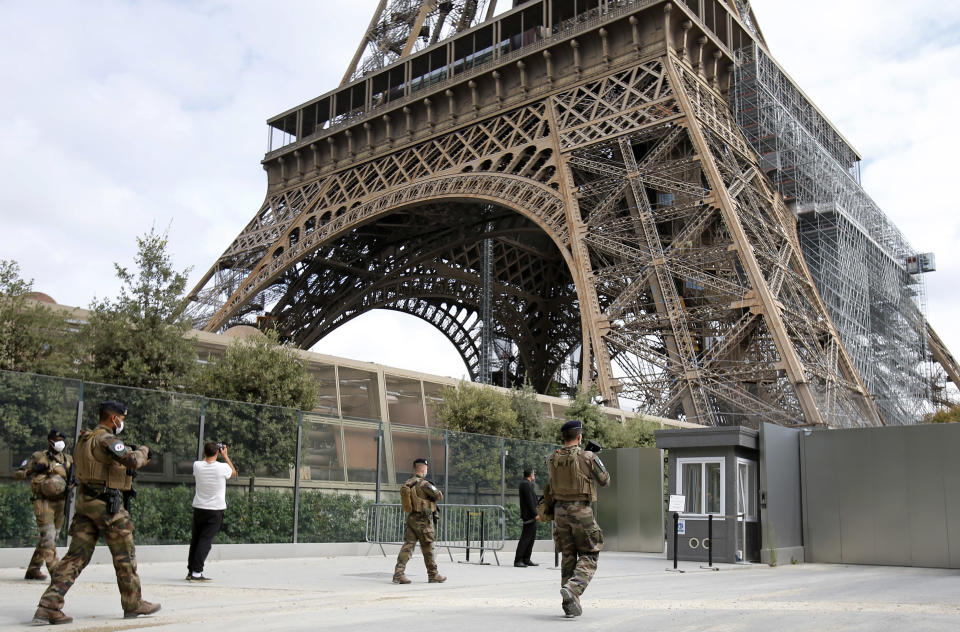 PARIS, FRANCE - JULY 15: French soldiers patrol next to the Eiffel Tower on the day of the reopening of the top floor on July 15, 2020 in Paris, France. After nearly three months of closure due to the coronavirus pandemic (COVID-19), the Eiffel Tower today opens its 3rd floor to the public. (Photo by Chesnot / Getty Images)