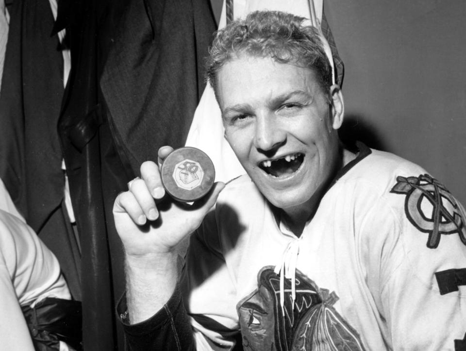 Bobby Hull holds puck with which he scored his 50th goal of the season in 1962.