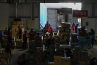 Workers prepare goods to load onto trucks at the Chinese online retailer JD.com's warehouse in Beijing on Tuesday, Nov. 9, 2021. China's biggest online shopping day, known as "Singles' Day" on Nov. 11, is taking on a muted tone this year as regulators crack down on the technology industry and President Xi Jinping pushes for "common prosperity." (AP Photo/Andy Wong)