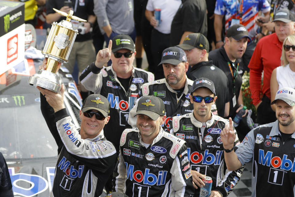 Kevin Harvick, left, celebrates after winning the NASCAR Brickyard 400 auto race at Indianapolis Motor Speedway, Sunday, Sept. 8, 2019, in Indianapolis. (AP Photo/Darron Cummings)