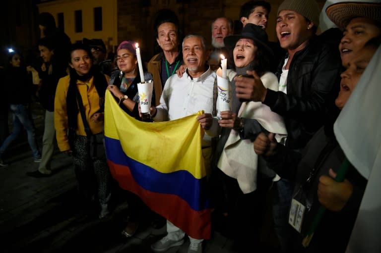 People celebrate on Bogota's main square, November 12, 2016, after the Colombian government and Marxist FARC rebels signed a new and revised peace deal to end 52 years of civil war