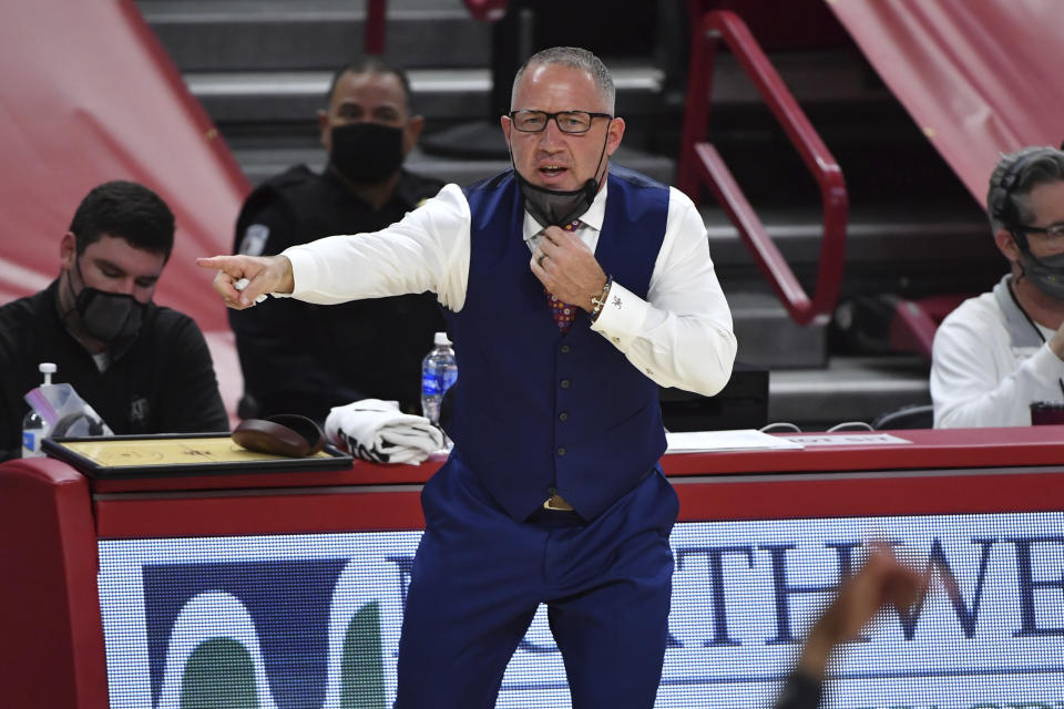 FILE - Texas A&M coach Buzz Williams talks to his team from the sideline as they play against Arkansas during the first half of an NCAA college basketball game in Fayetteville, Ark., in this Saturday, March 6, 2021, file photo. Williams was expected to help the Aggies reach the next level when he was hired after guiding Virginia Tech to three straight NCAA tournaments, capped by a trip to the Sweet 16 in 2019. The Aggies went 16-14 in his first season before things fell apart last season. The Aggies finished 8-10 and 2-8 in Southeastern Conference play last year in a season with multiple stops and starts because of the coronavirus.(AP Photo/Michael Woods, File)