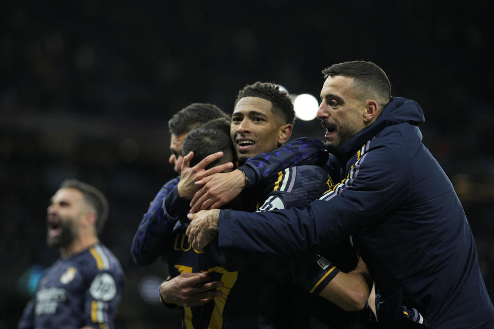 Real Madrid players celebrate at the end of the Champions League quarterfinal second leg soccer match between Manchester City and Real Madrid at the Etihad Stadium in Manchester, England, Wednesday, April 17, 2024. (AP Photo/Dave Shopland)