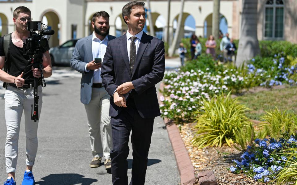 New College of Florida trustee Christopher Rufo approaches protesters following Governor Ron DeSantis' signing of several higher education bills on the New College Campus on May 15, 2023.