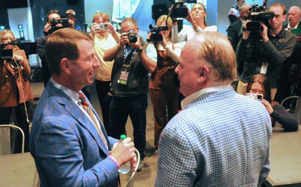 Clemson coach Dabo Swinney, left, and Kentucky coach Mark Stoops meet at Thursday’s Gator Bowl press conference ahead of Friday’s matchup in Jacksonville, Florida.