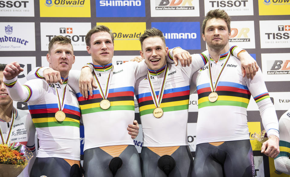 The team from the Netherlands, Roy van den Berg, Jeffrey Hoogland, Harrie Lavreysen and Matthijs Buchli celebrate during the winners ceremony, after winning the gold medal in the team sprint competition during the Track Cycling World Championships in Berlin, Germany, Wednesday, Feb. 26, 2020. ( Sebastian Gollnow/dpa via AP)