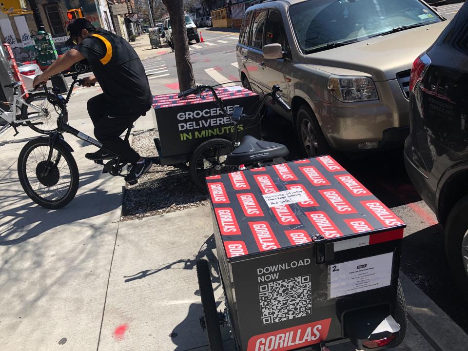 A worker sets to make a delivery on a bicycle in front of Gorillas mini-warehouse in the Williamsburg section of the Brooklyn borough of New York on Monday, April 12, 2022. Gorillas is one of several companies that venture capitalists have poured billions into in the latest pandemic delivery craze.They typically deliver from mini-warehouses in residential and commercial neighborhoods. (AP Photo/Tali Arbel)