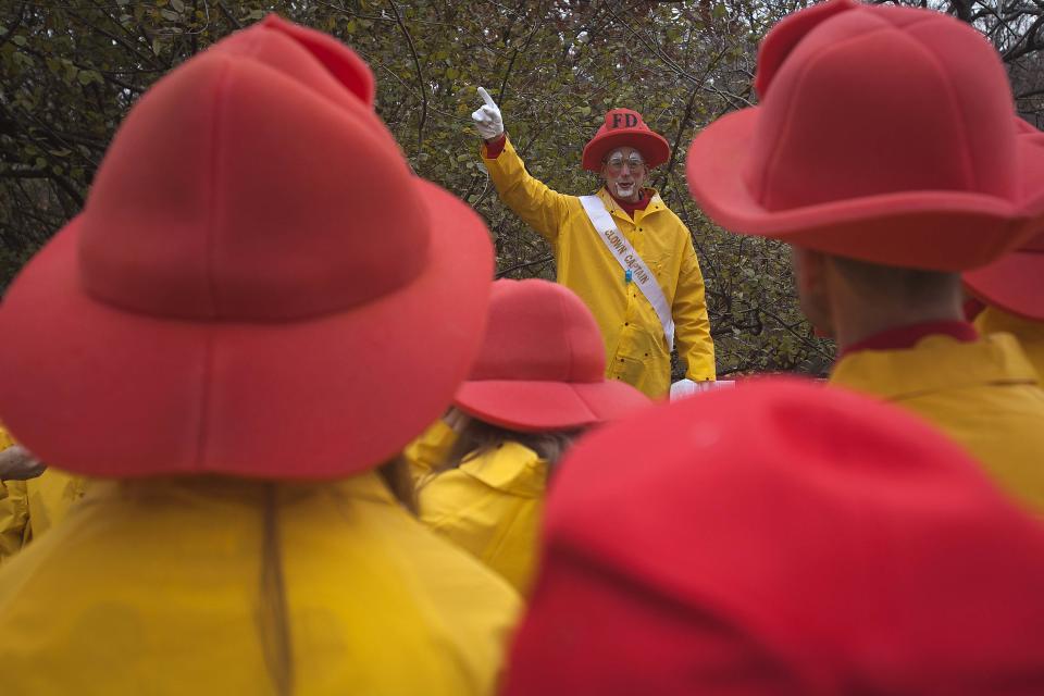 A clown captain gives last minute instructions to his fellow clowns as they prepare to participate in the Macy's Thanksgiving Day Parade in New York, November 27, 2014. REUTERS/Carlo Allegri (UNITED STATES - Tags: SOCIETY)