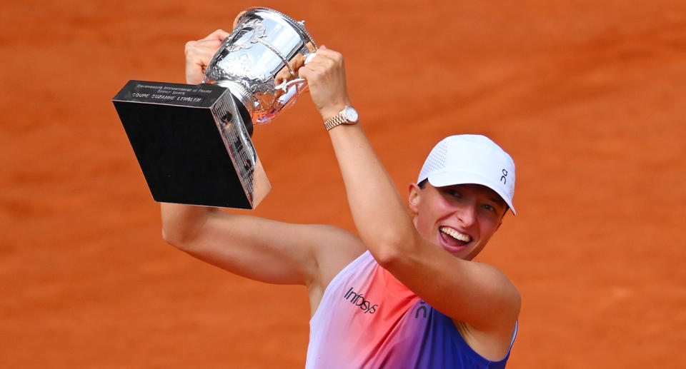 Seen here, Iga Swiatek lifts the French Open trophy aloft after winning the women's final.