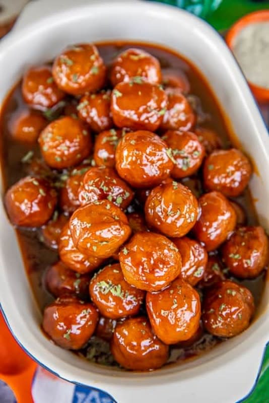 <p>Plain Chicken</p><p>Your party guests will love these so much, you might need to double the recipe.</p><p><strong>Get the recipe: <a href="https://www.plainchicken.com/sweet-spicy-meatballs/" rel="nofollow noopener" target="_blank" data-ylk="slk:Sweet & Spicy Meatballs;elm:context_link;itc:0;sec:content-canvas" class="link rapid-noclick-resp">Sweet & Spicy Meatballs</a></strong></p>
