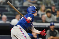 Texas Rangers' Brock Holt follows through on an RBI single during the fourth inning of a baseball game against the New York Yankees Wednesday, Sept. 22, 2021, in New York. (AP Photo/Frank Franklin II)