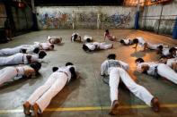 Members of the Acorda Capoeira (Awaken Capoeira) group train at a local school in the Rocinha favela in Rio de Janeiro, Brazil, July 21, 2016. REUTERS/Bruno Kelly