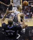 San Antonio Spurs' Tony Parker (9), of France, crashes into Minnesota Timberwolves' Dante Cunningham (33) while trying to score during the first half of an NBA basketball game on Sunday, Jan. 12, 2014, in San Antonio. Parker was called for charging. (AP Photo/Eric Gay)