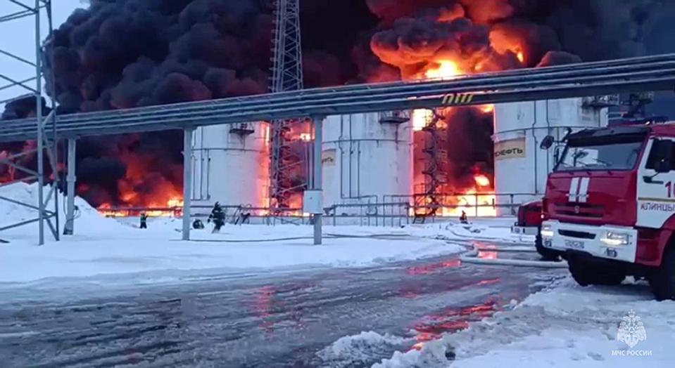 In this photo taken from video released by Governor of Bryansk Region Alexander Bogomaz telegram channel AV BogomaZ on Friday, Jan. 19, 2024, Russian Emergency Ministry employees work at the side of fire of oil reservoirs after the drone reached Klintsy, a city in Bryansk Region of Russia, about 60 kilometers (40 miles) from the Russia-Ukrainian border. A Russian official says a Ukrainian drone has struck an oil storage depot in western Russia, causing a massive blaze. (Governor of Bryansk Region Alexander Bogomaz telegram channel AV BogomaZ via AP)