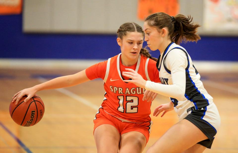 Sprague's Carly Skogstad (12) moves around the parameter against McNary's Avery Buss (23) during the first half at McNary High School in Keizer, Ore. on Thursday, Jan. 5, 2023.