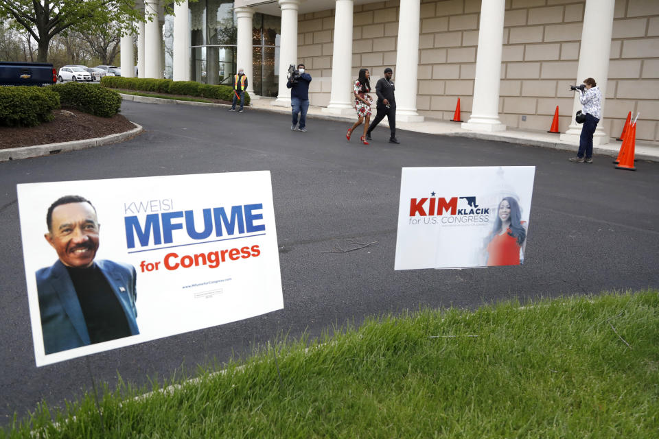 Kimberly Klacik, top center, the Republican candidate in the 7th Congressional District special election, walks with her security detail as she visits campaign supporters outside of a voting center, Tuesday, April 28, 2020, in Windsor Mill, Md. Klacik is going up against Democrat Kweisi Mfume in the election to fill a seat left open by the death last October of Congressman Elijah Cummings. An election that has been dramatically reshaped by the coronavirus outbreak. (AP Photo/Julio Cortez)