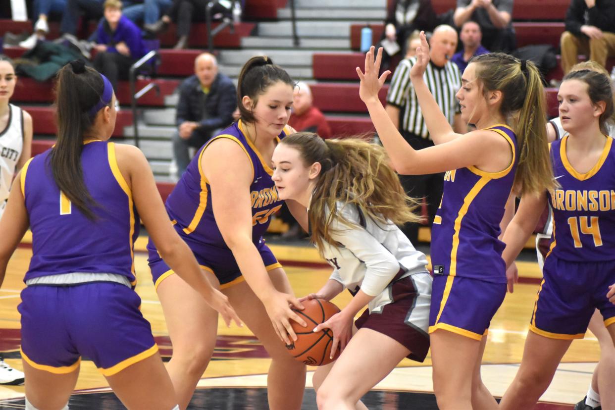 Union City's Addy Rumsey fights for control of the ball while the Bronson defense descends on her. Pictured for Bronson are, from left, Haylie Wilson, Helena Eley, Ava Hathaway, and Brealyn Lasky.