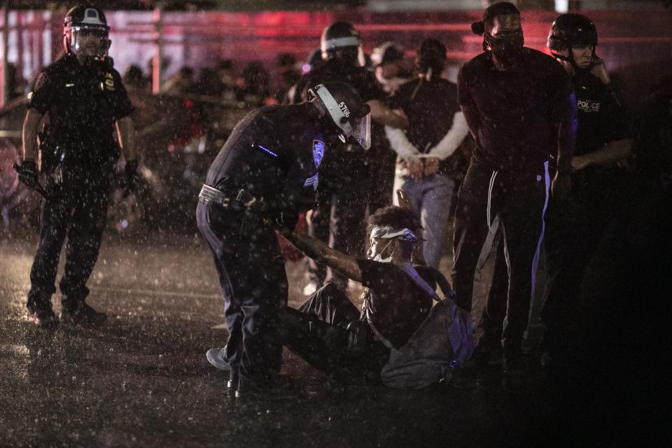 Police arrest protesters for breaking an imposed curfew by marching through Manhattan Wednesday, June 3, 2020, in New York, during a solidarity rally calling for justice over the death of George Floyd. Floyd died after being restrained by Minneapolis police officers on May 25. (AP Photo/Wong Maye-E)