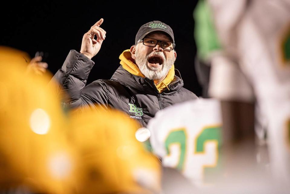 Bryan Station head coach Phillip Hawkins congratulates his team after the Defenders defeated the Ballard Bruins 24-21 in the Class 6A state semifinals on Nov. 24.