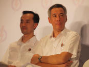 PM Lee sits with PAP Punggol East candidate Koh Poh Koon at the party's final rally. (Yahoo! photo/Alvin Ho)
