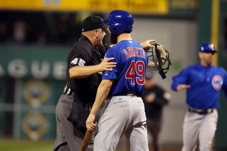 Oct 7, 2015; Pittsburgh, PA, USA; Chicago Cubs starting pitcher Jake Arrieta (49) is held back by umpire Jeff Nelson (45) after he was hit by a pitch by the Pittsburgh Pirates during the seventh inning in the National League Wild Card playoff baseball game at PNC Park. Charles LeClaire-USA TODAY Sports