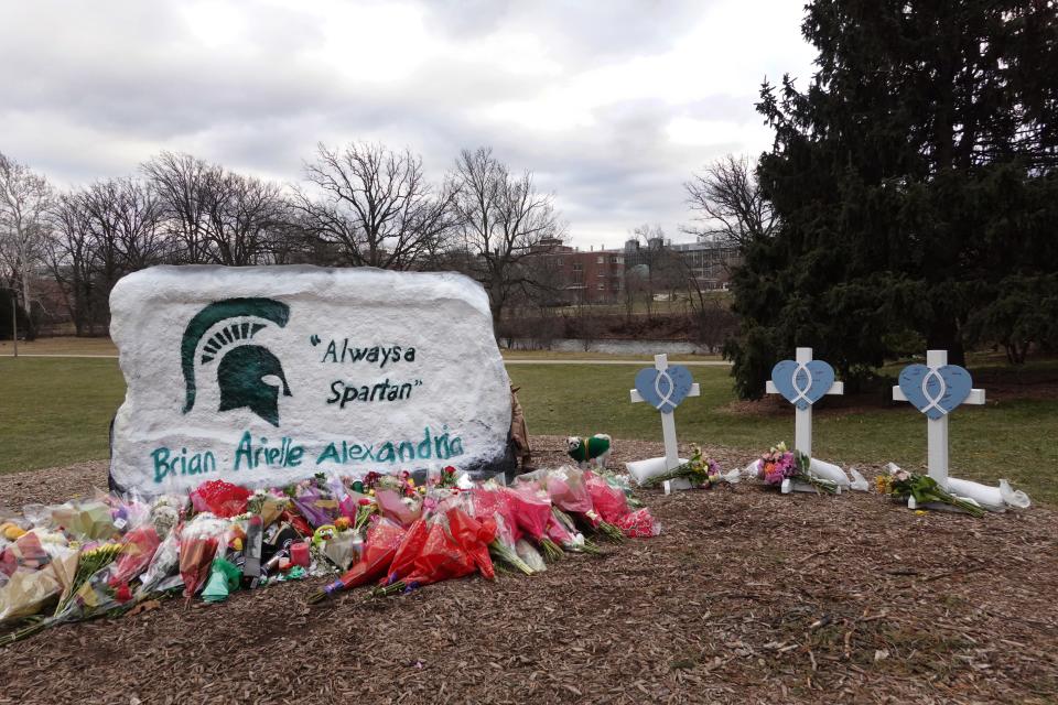 "The Rock" on the Michigan State University campus had a pro-gun message painted overnight, but that was changed Wednesday as the site has become a memorial to those killed by a gunman Monday.