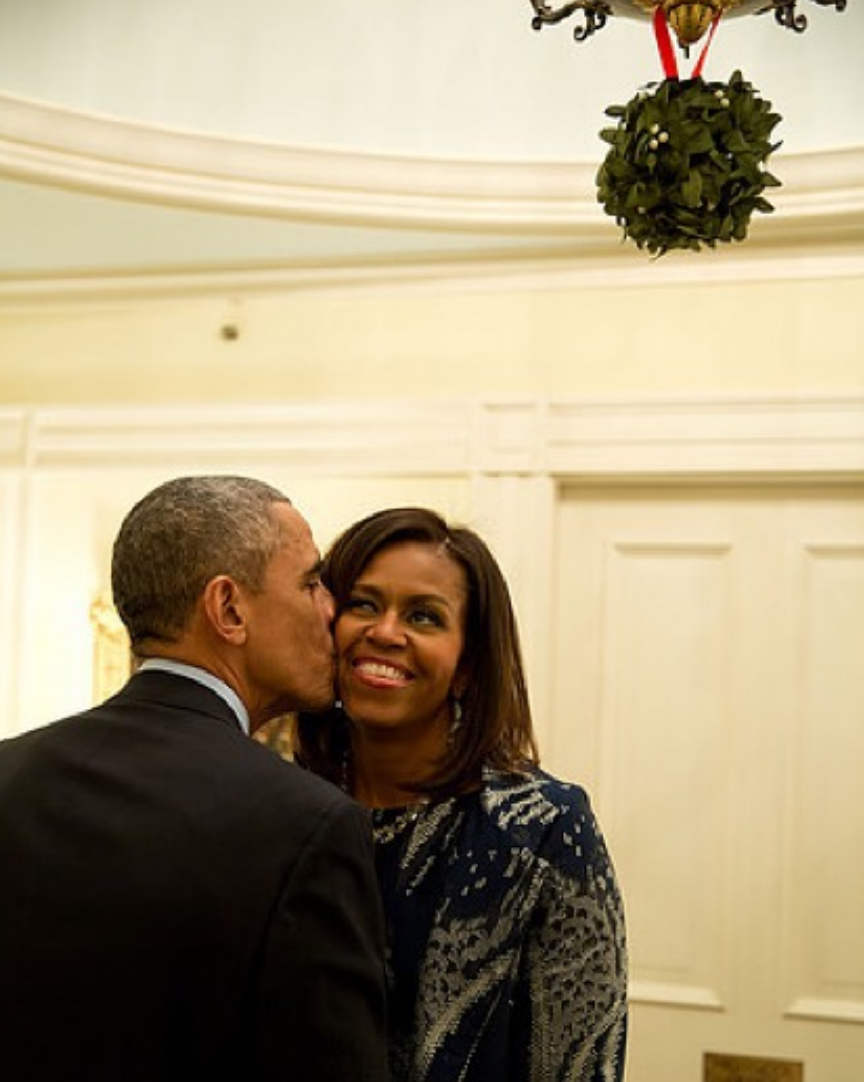 <p>Barack kisses Michelle under the mistletoe in 2015. <em>[Photo: Michelle Obama/ Instagram]</em> </p>