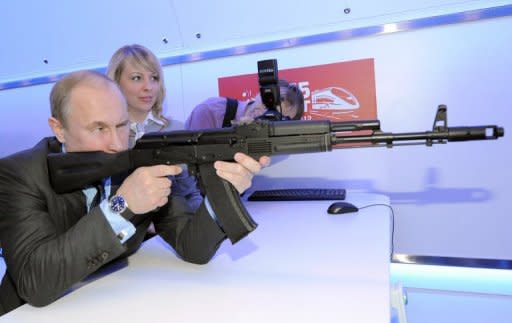 Russia's President-elect Vladimir Putin takes aim with a replica of Kalashnikov assault rifle in Moscow on April 26. Putin has praised Russia's close ties with "good friends" China during a visit by the country's likely next premier, Li Keqiang, to Moscow