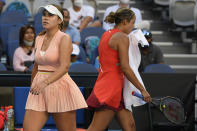 Sofia Kenin, left, of the U.S. walks past compatriot Madison Keys during their first round match at the Australian Open tennis championships in Melbourne, Australia, Monday, Jan. 17, 2022. (AP Photo/Andy Brownbill)