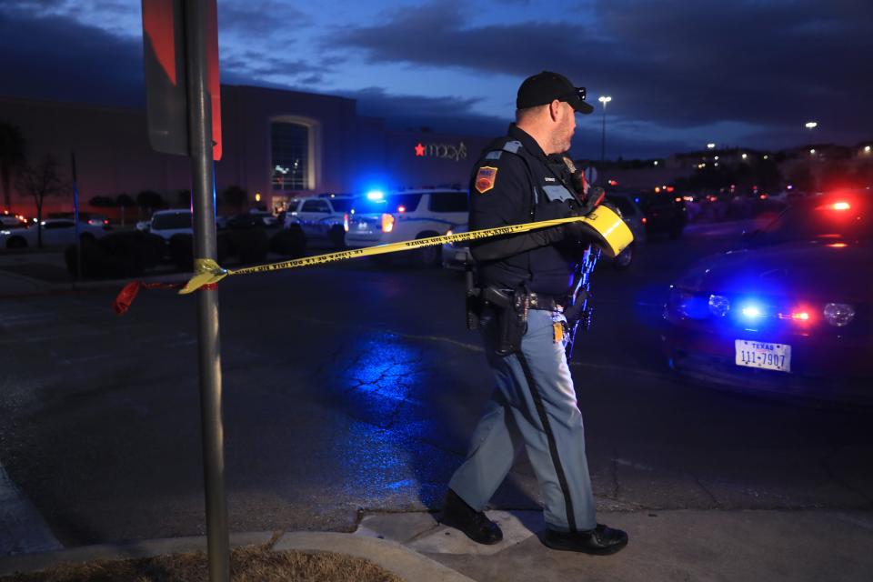 An El Paso police officer puts up crime-scene tape after a 16-year-old boy allegedly killed a 17-year-old boy in a shooting inside Cielo Vista Mall in February, part of a growing problem of teen gun violence.