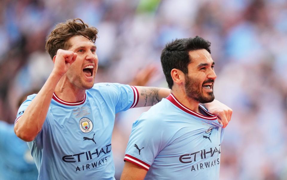  Ilkay Guendogan of Manchester City celebrates with teammate John Stones - Getty Images/Tom Flathers