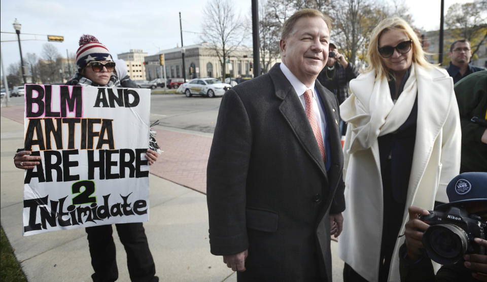 Mark and Patricia McCloskey, right, walk around the grounds of the courthouse during Kyle Rittenhouse's trial at the Kenosha County Courthouse in Kenosha, Wis., on Tuesday, Nov. 16, 2021. (AP Photo/Kenosha News, Sean Krajacic)/The Kenosha News via AP)